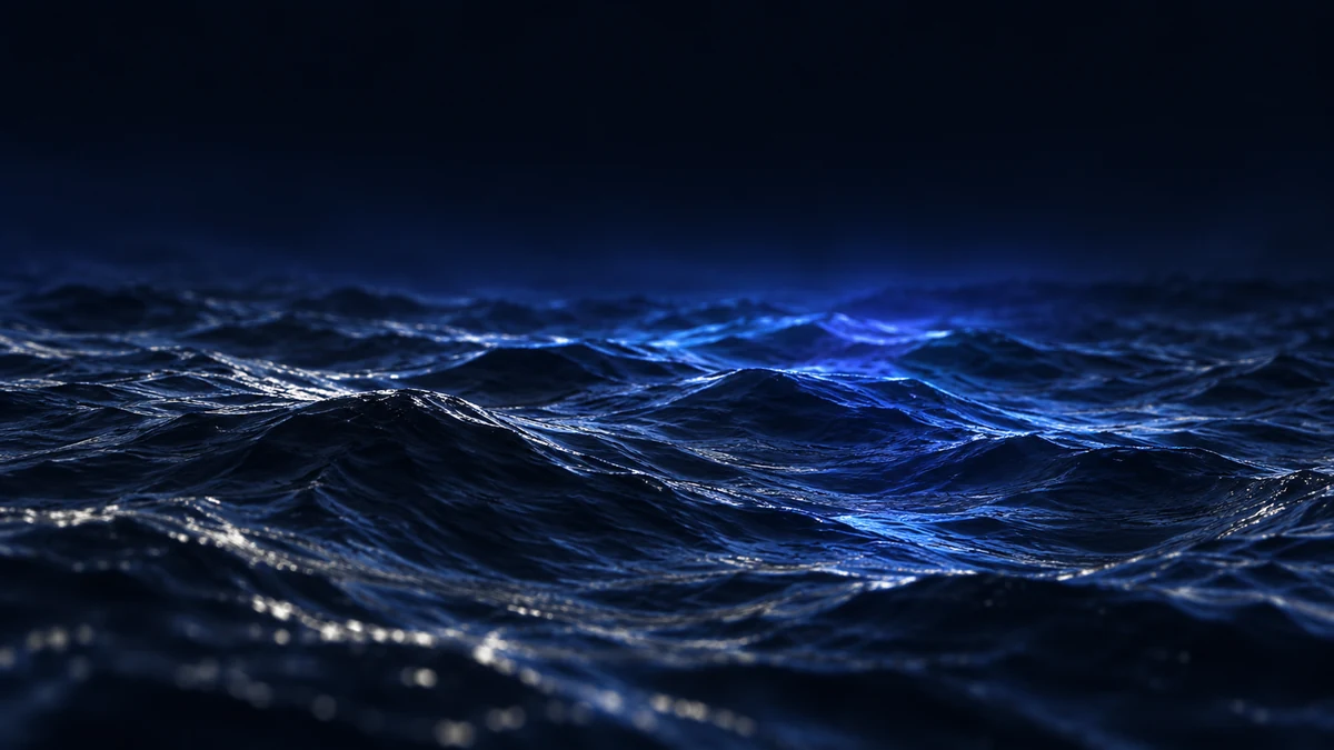 Blue waves moving across a dark ocean