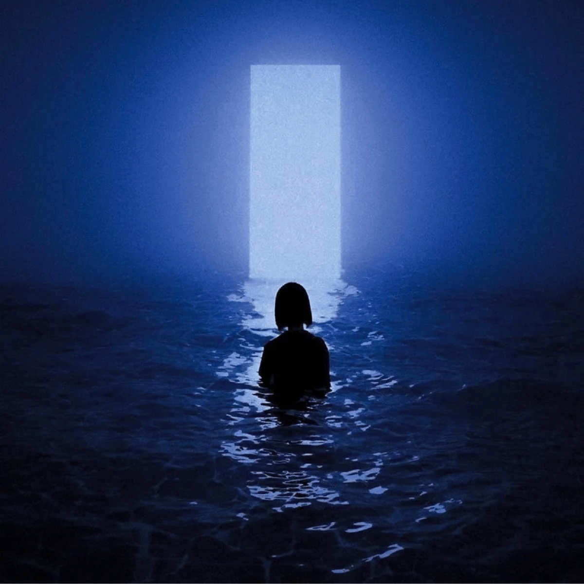 A person facing an illuminated doorway
