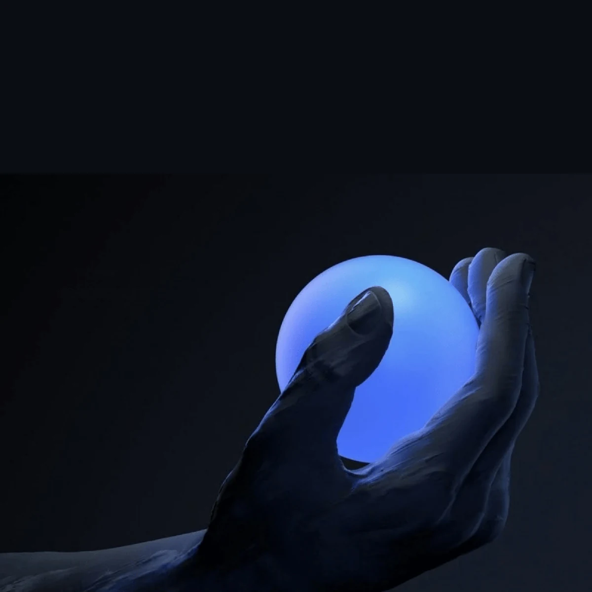 A hand holding a glowing blue sphere